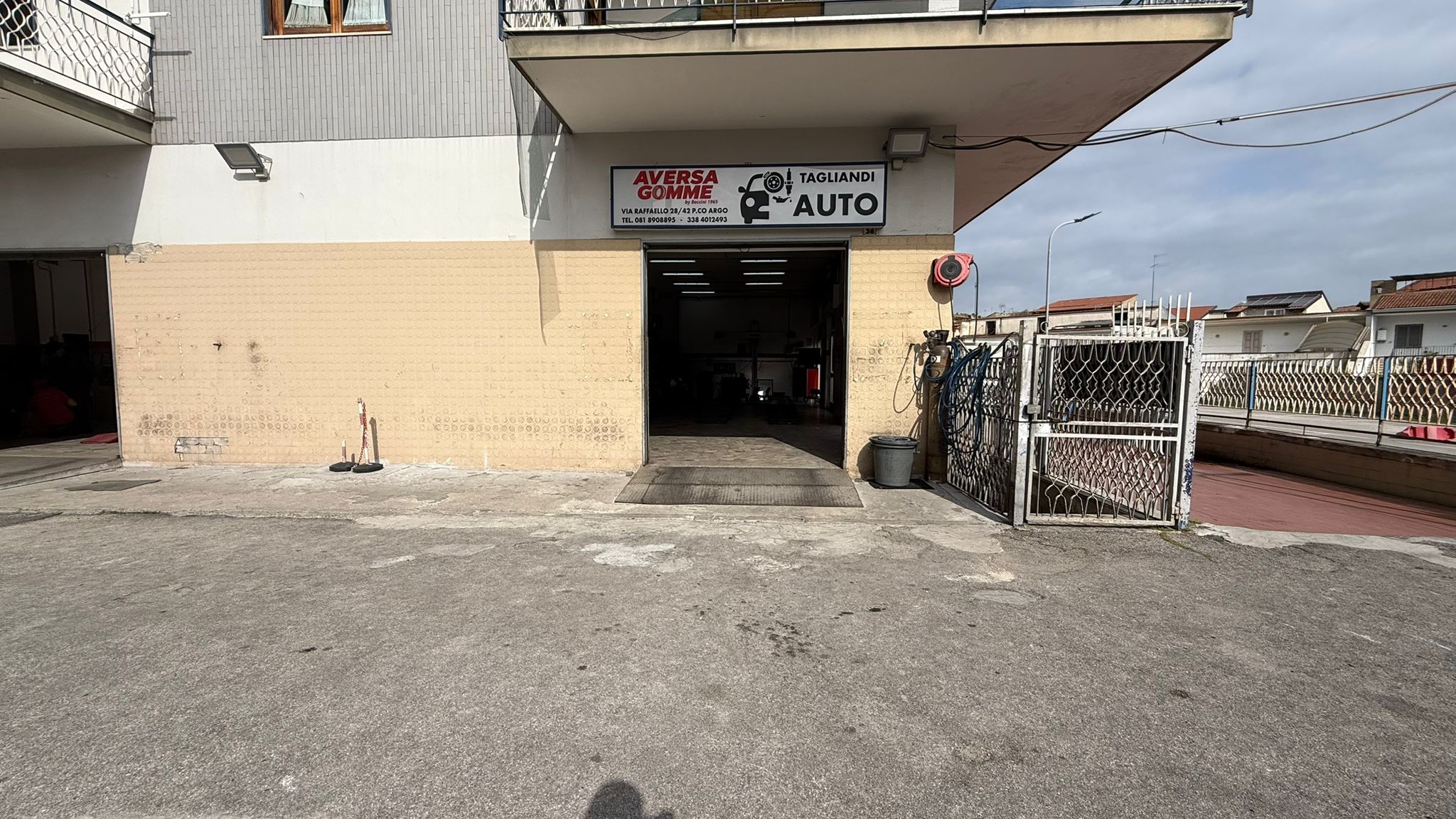 Facciata di Aversa Gomme con aperture dell'officina verso l'esterno